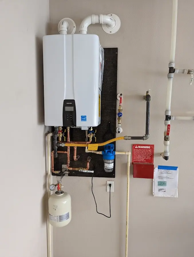 Professional plumber installing copper piping in a Pleasant Hills home